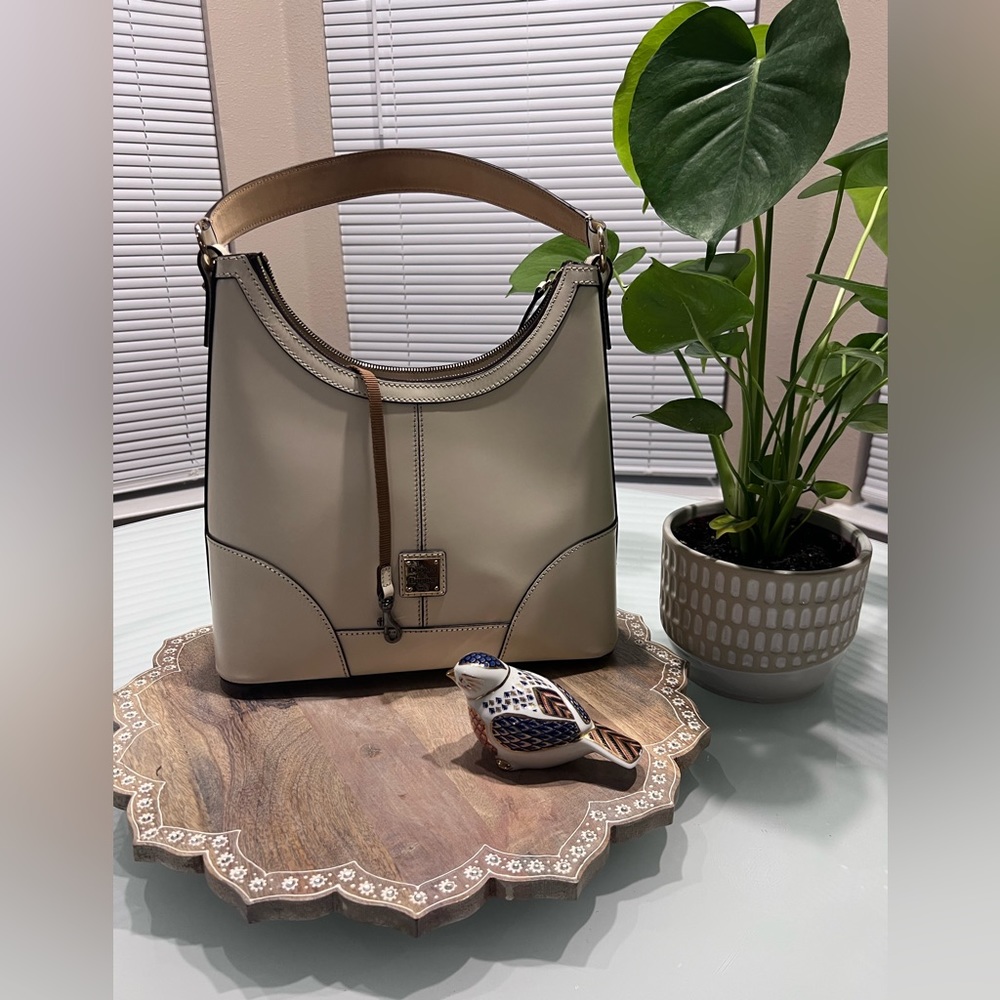 Dooney and Bourke light beige, leather shoulder bag like new condition